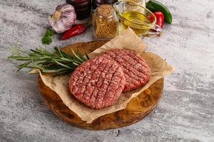 Raw burger cutlet for grill photo