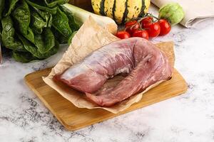 Uncooked raw pork tenderloin with spices photo