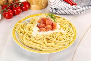 Pasta spaghetti with salmon and stracciatella photo