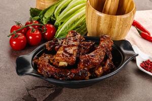 Grilled pork ribs in barbecue sauce photo