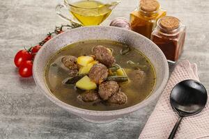 Soup with meatball and potato photo