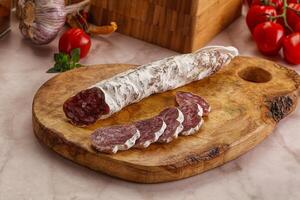 Spanish dry pork sausage Fuet photo