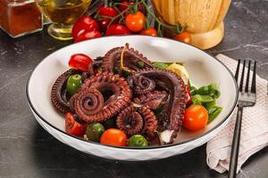 Salad with octopus tentacle and vegetables photo