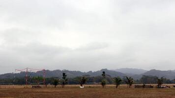 View of hills covered in mist from a field photo