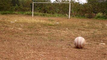 Plastic ball on dry ground field photo