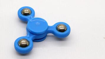 Blue fidget spinner isolated photo