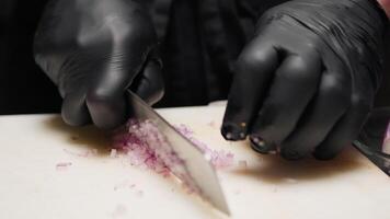 Cutting and slicing small pieces of onion for a dish video