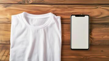 AI generated Top view of blank white tshirt unisex mockup with empty screen smartphone for design template on wood background photo