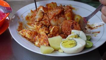 Siomay is a streetfood in Indonesia, contains of tofu, boiled egg, steamed potato, cabbage, and fish meatball, mixed with peanut sauce. video