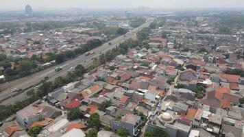 Aerial view of toll road that surrounded by residential area in Cakung, East Jakarta, Indonesia video