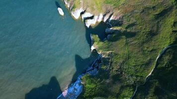 Aerial view of a rugged coastline with cliffs and sea. video