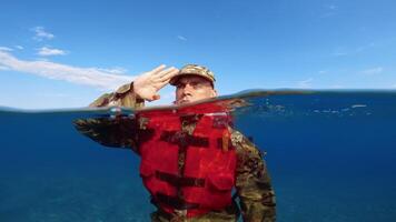 soldier salutes at the ocean video