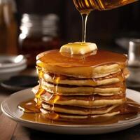 AI generated Pouring the maple syrup over the big stack of pancakes from the syrup bottle. Closeup of delicious pancake with butter, food photography isolated on blurred background. photo