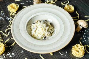 White Bowl Filled With Pasta on Wooden Table photo