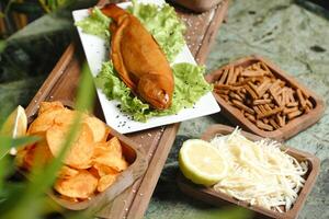 Wooden Tray Filled With Various Types of Food photo
