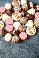 Assorted Chocolates Piled on Table photo