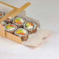 Box Filled With Sushi on White Table photo