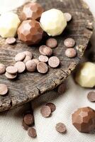 Wooden Spoon Filled With Chocolates on Table photo