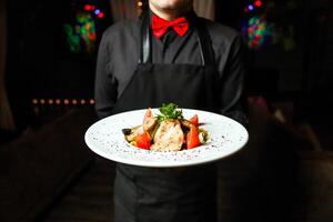 Man Holding Plate of Food in Hands photo