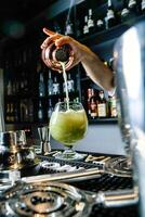 Person Pouring Fresh Orange Juice Into a Glass photo