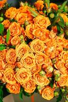 A Bouquet of Orange Flowers With Green Leaves photo