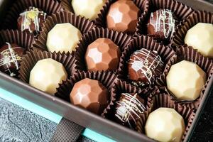 Assorted Chocolates Filling a Box on a Table photo