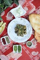 Table With Assorted Food Plates and Dipping Sauces photo