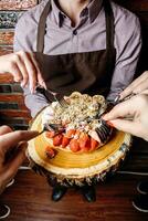 Person Cutting Into a Cake With a Knife and Fork photo