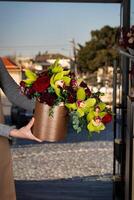 Woman Holding Vase With Flowers photo