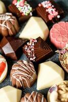 Close Up of Assorted Chocolates in Various Flavors and Shapes photo