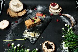 Black Plate Topped With Slices of Cake photo