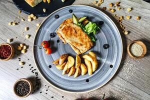 Deliciously Arranged Plate of Food on a Rustic Wooden Table photo