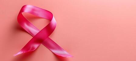 AI generated Breast cancer awareness month symbol  pink ribbon isolated on pink background with copy space photo