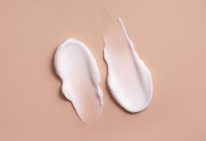 Cosmetic smear of cream texture on a beige background. Skin care. photo