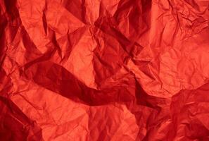 Crumpled red sheet of paper. Paper texture. Background for designers. Abstract background texture photo