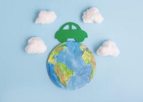 Green car and planet earth. Ecological transport. Ecology concept. photo