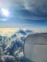 View from an airplane of the engine and the clouds over the Maldives. photo