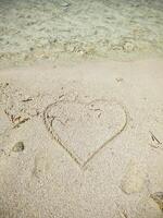 A romantic heart painted in the sand of the Maldives. photo