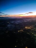 View from an airplane window at night of a city with many lights. photo