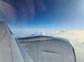 View from an airplane of the engine and the clouds over the Maldives. photo