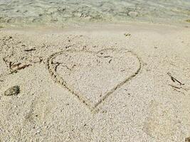 A romantic heart painted in the sand of the Maldives. photo