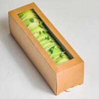 Cardboard Box Filled With Green Vegetables on Table photo