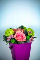 Purple Vase Filled With Flowers on Table photo