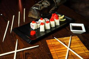Black Plate With Sushi and Chopsticks photo