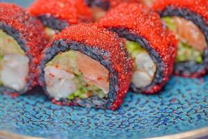 Blue Plate With Sushi Covered in Sauce photo