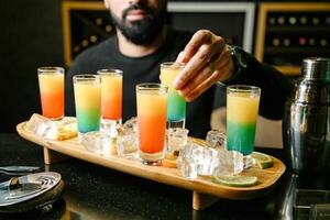 Man Sitting at Table With Tray of Drinks photo