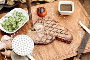 Wooden Cutting Board With Steak and Vegetables photo