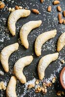 Table With Assorted Cookies, Nuts, and a Bowl of Powdered Sugar photo
