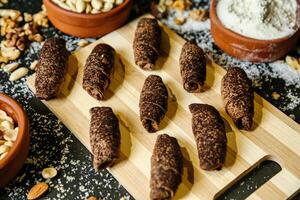 Wooden Cutting Board With Chocolate Covered Donuts photo