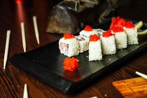 Black Plate With Sushi and Chopsticks photo